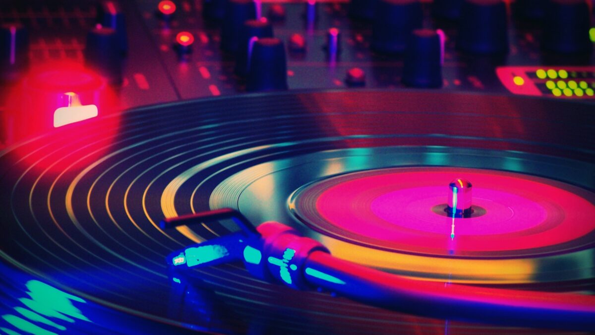 A stylized photo of a record on a turntable, with colorful lights in various places