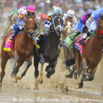 Multiple horses racing around a track