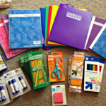 An array of school supplies laid out on a floor